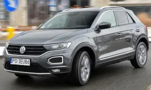Szary Volkswagen T-Roc w ruchu miejskim. Wiele osób szuka volkswagen t-roc opinie, by podjąć decyzję o zakupie.