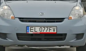 Przód błękitnego samochodu z widocznym logo Daihatsu i tablicą rejestracyjną EL 077FV.