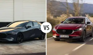 Szary Mazda 3 sedan obok czerwonego crossovera na drodze.