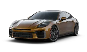 Złoty Porsche Panamera, luksusowy sedan sportowy, prezentuje swoje eleganckie linie i moc.