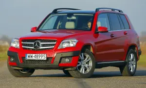Czerwony Mercedes GLK na drodze. Kierowca w środku. Wiele osób szuka mercedes glk opinie przed zakupem.