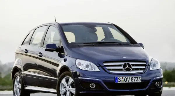 Ciemnoniebieski Mercedes W245 z błyszczącym lakierem stoi na drodze.