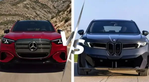 Czerwony mercedes sedan kontra ciemny BMW. Dwa luksusowe auta na tle górskiego krajobrazu i nieba.
