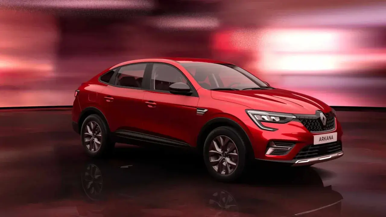 Czerwony Renault Arkana na tle czerwonych świateł. Sprawdź atrakcyjną renault arkana cena i zamów już dziś!